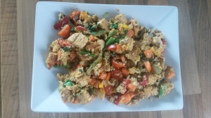 A pile of vegetable scrambled eggs on a rectangular plate.
